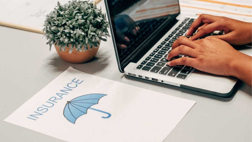 A picture of an umbrella, and hands typing on a laptop keyboard